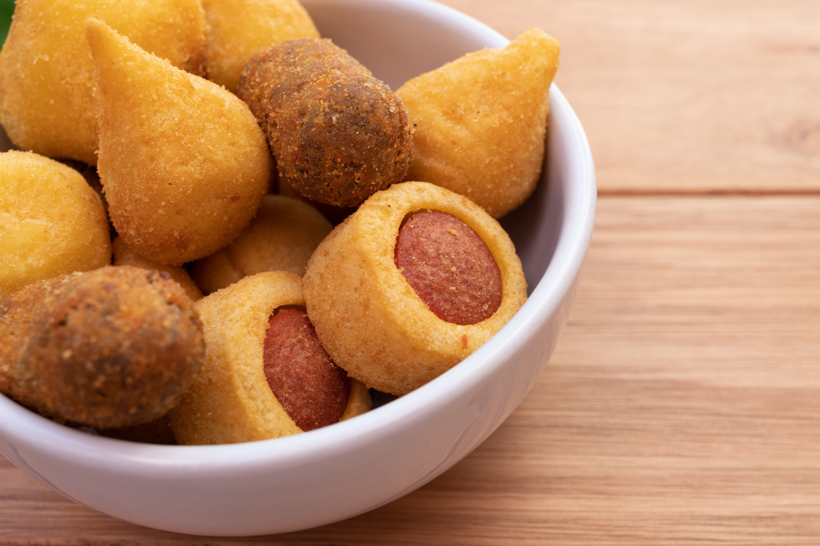 Finger food. Brazilian deep fried savory snack mix with "coxinha", "croquette", "cheese ball", "risóles" and "sausage snack"
